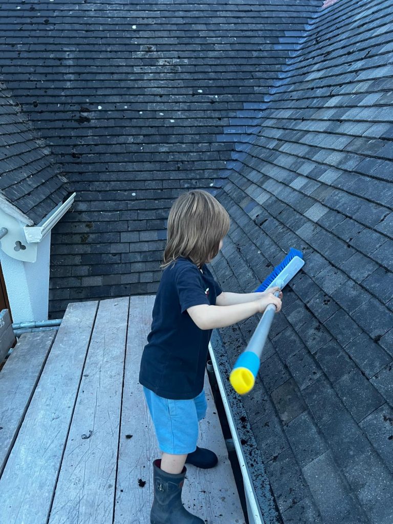 child-helping-clean-the-roof-during-easter-holidays-at-home-loving-life